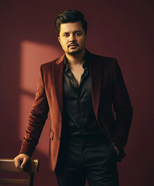 Agha Muqeet in a burgundy blazer